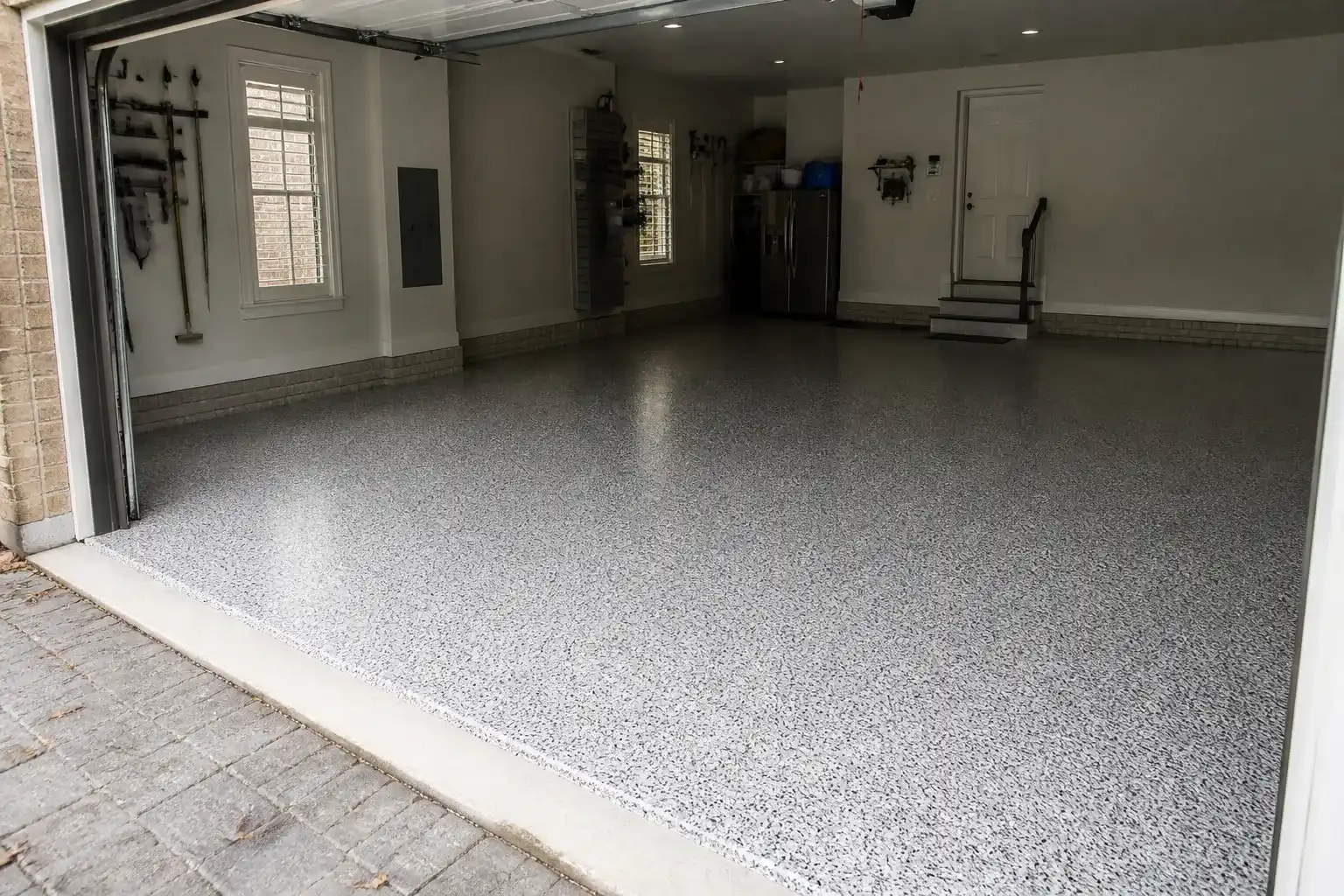 Finished gray flake garage floor coating in a clean garage