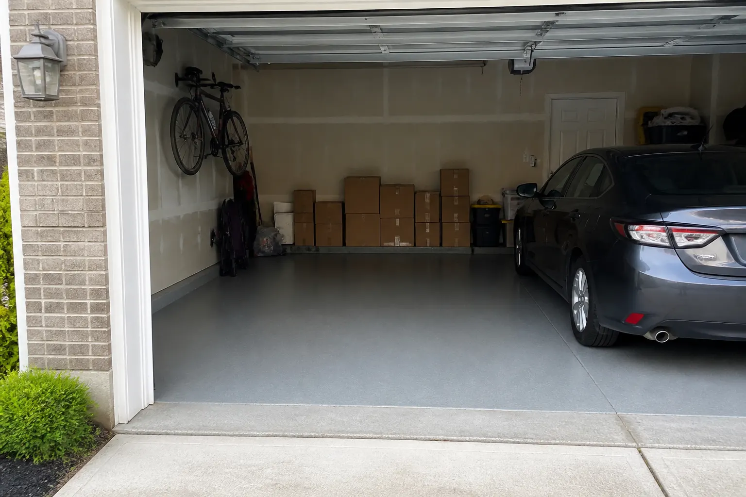 Two car garage with a solid colour epoxy floor