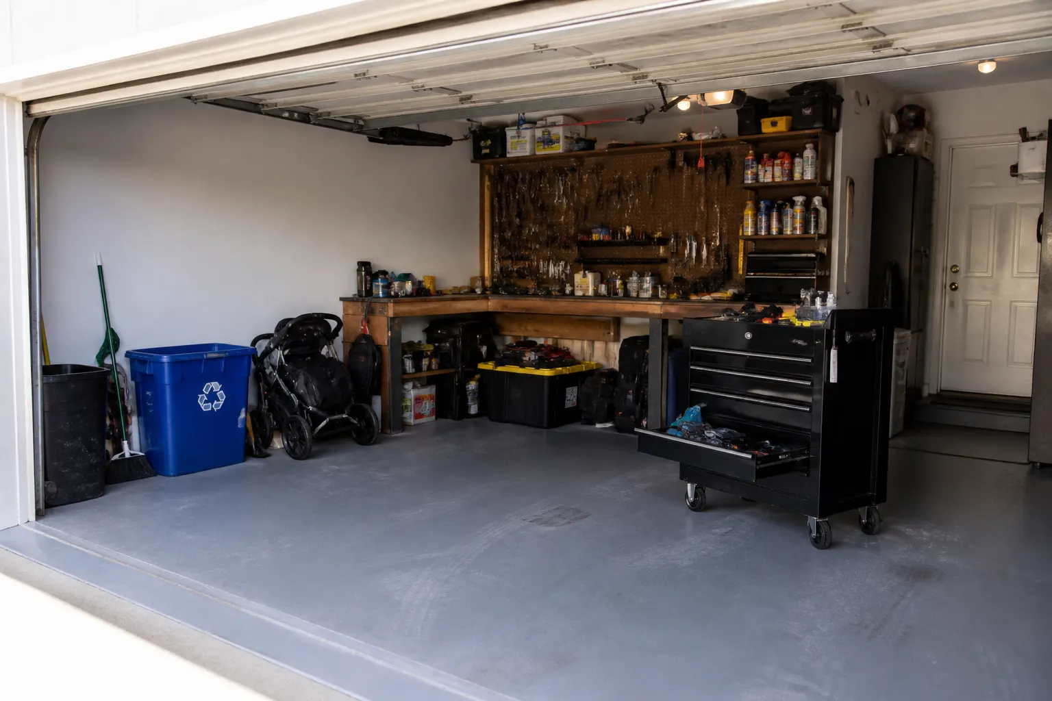 Coated garage floor in Marietta with workbench and storage