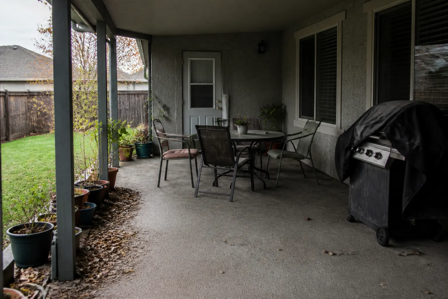 Covered back patio with a textured coated concrete floor