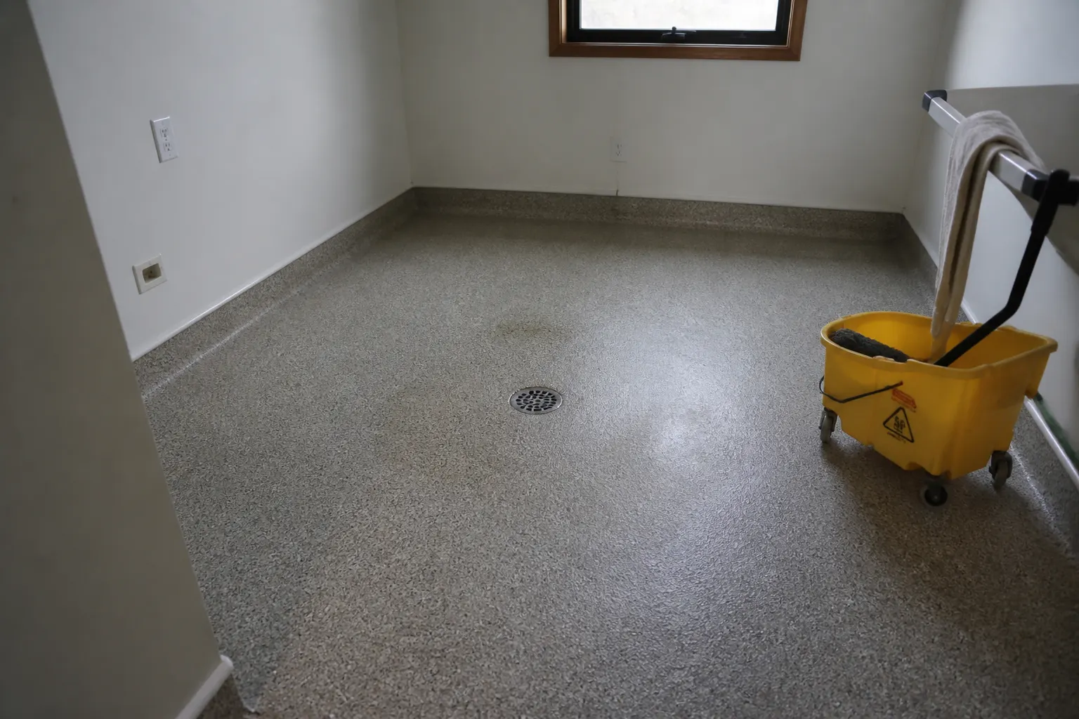 Quartz broadcast floor coating around a floor drain