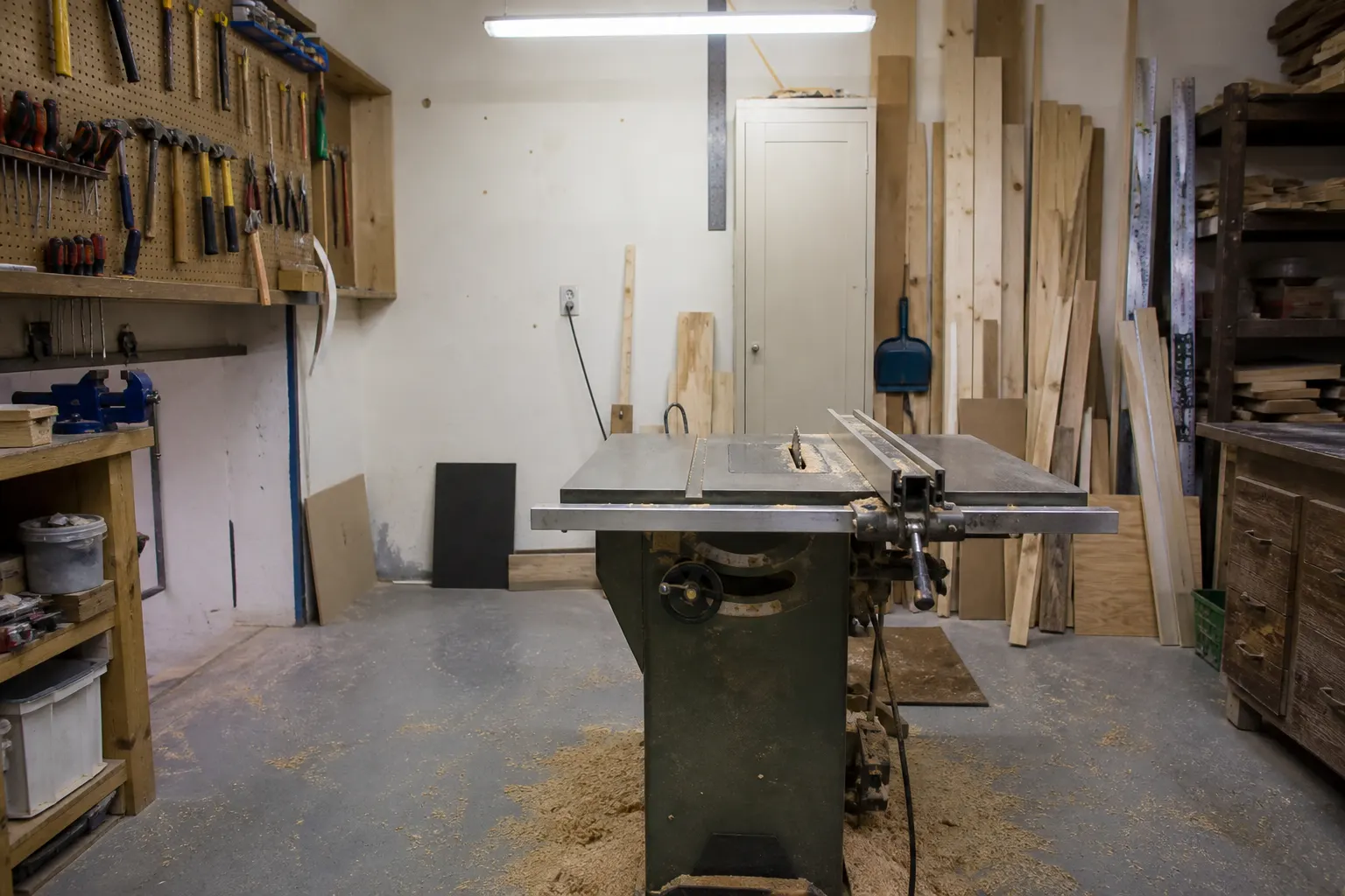 Home workshop with a coated concrete floor and table saw